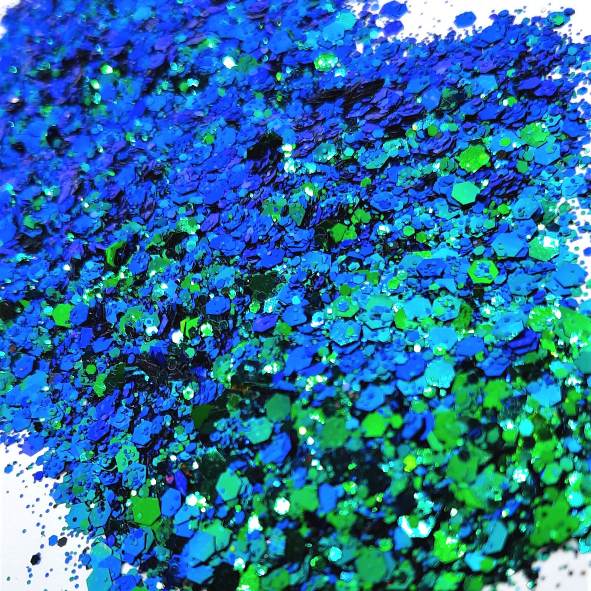 Poseidon Glitter Mix  A a strong and bright colour mix blues & green flecked with holographic & iridescent rainbow colours, so pretty! Perfect for a nautical sea inspired God look!